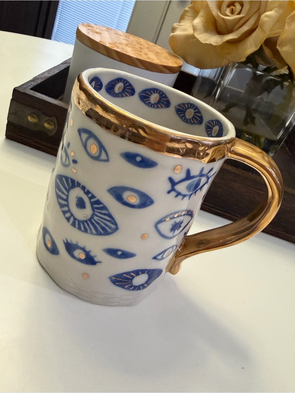 Anthropologie White Ceramic Mug with Blue Eye Motif and Gold Trim
